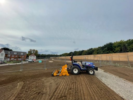 Agricultural tractor and seeder forming finished seed bed for Bellway Homes landscaping in Sittingbourne