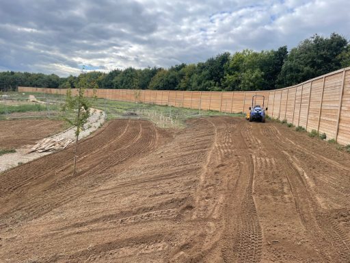 Tractor and rotavator carrying out seed bed preparation for Bellway Homes housing development in Sittingbourne